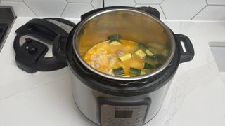 Instant Pot Duo Crisp & Air Fryer on a kitchen countertop being used to cook curry