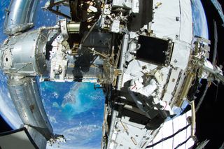 Astronauts Outfitting ISS during spacewalk