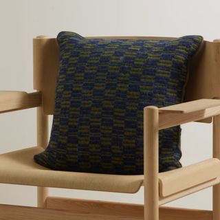 square cushion with dark blue and green pattern