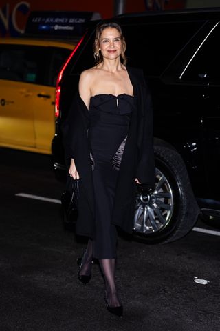 A photo of Katie Holmes dressing up for pre-NYFW cocktail party hosted by Michael Kors.