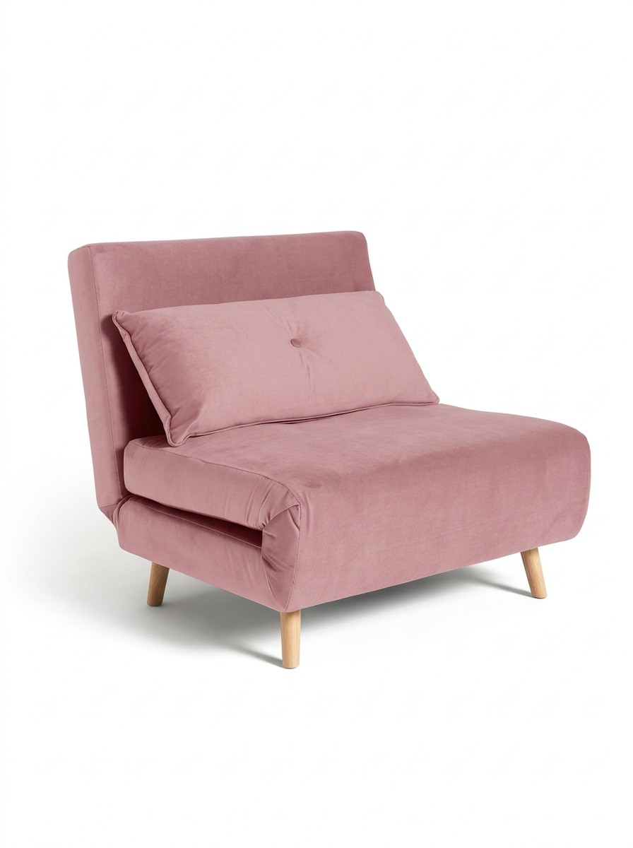 A small chair bed upholstered in pink velvet