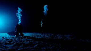 Divers at NASA's Neutral Buoyancy Laboratory have turned off the lights to experience how astronauts would feel on the moon's pole.