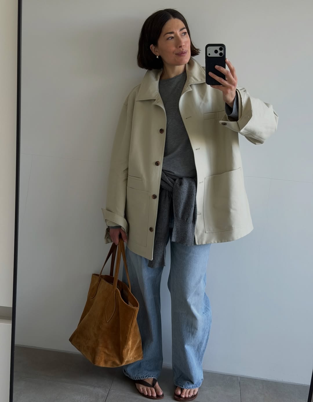 Influencer Lucy Alston wearing grey t-shirt, straight jeans and worker jacket.