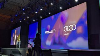 Sumit Dhawan, president at VMware, and Dr Henning Loeser, head of production at Audi Production Lab, Audi AG, on stage at VMware Explore Barcelona.