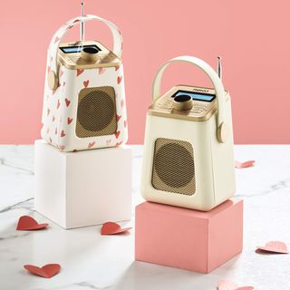 white fm radio with paper hearts and pink wall