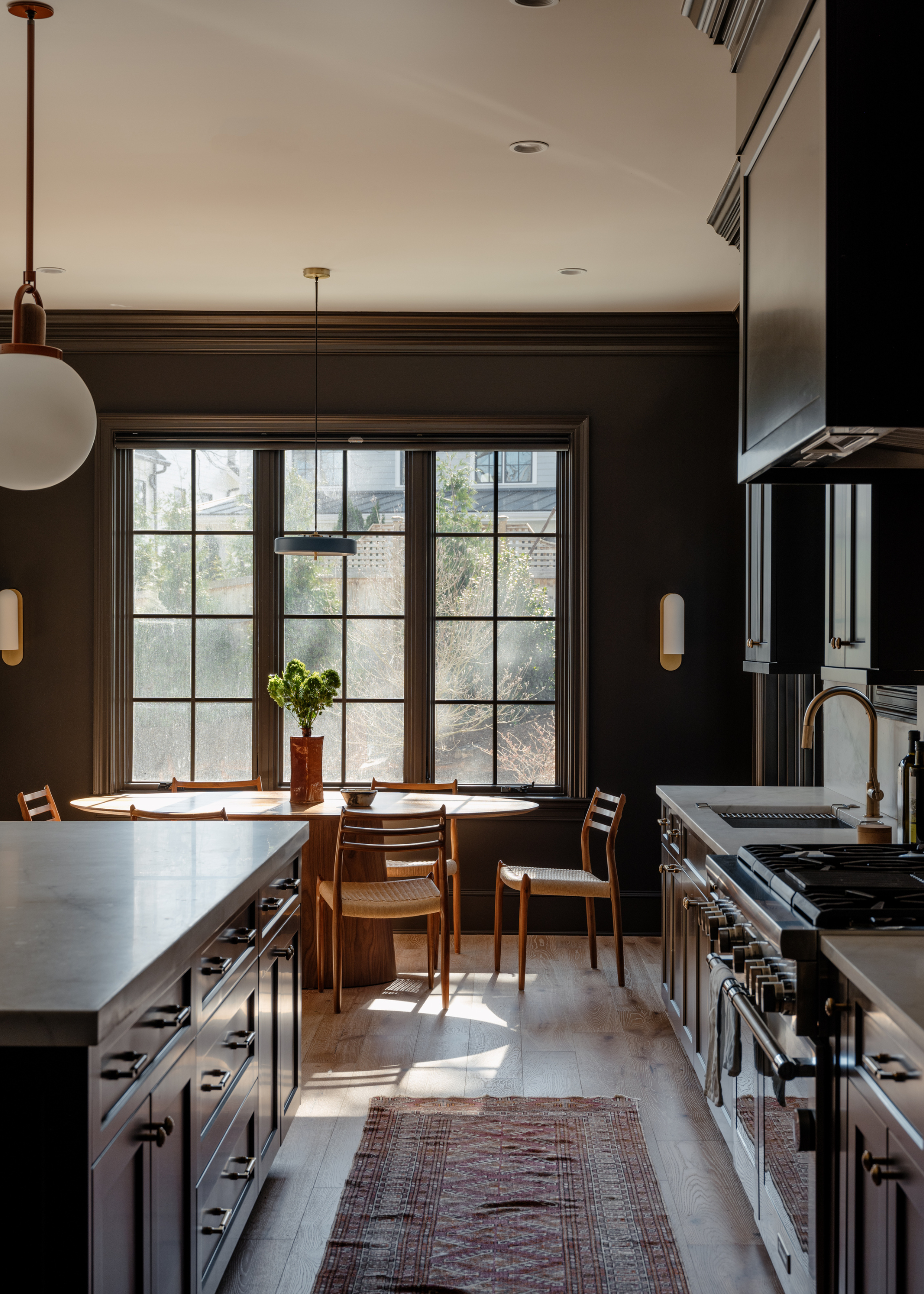 beautiful kitchen with dark painted cabinetry and walls