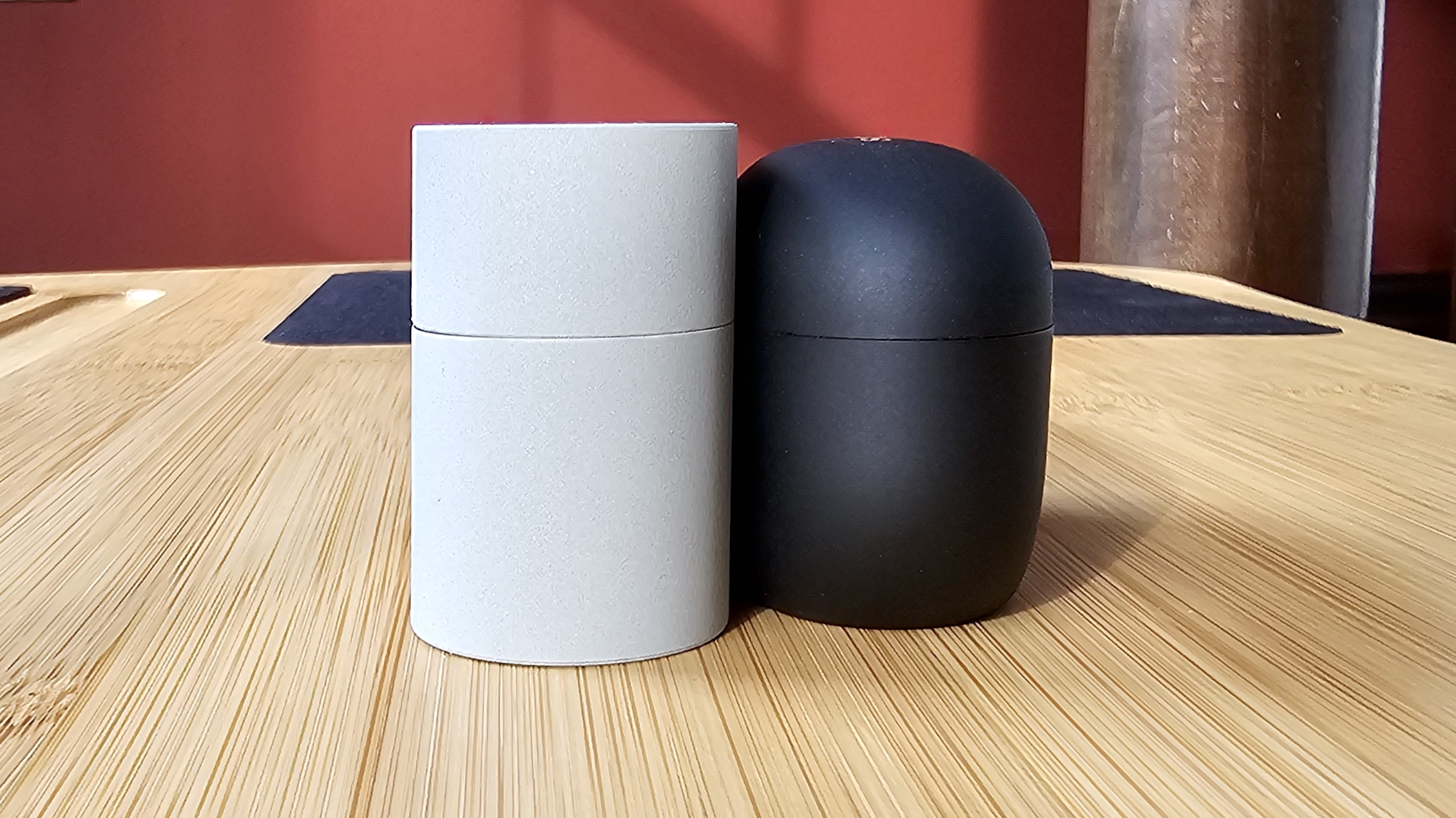 The Sony WF-1000XM6 and WF-1000XM5 side by side in a comparison, on a light wood table 