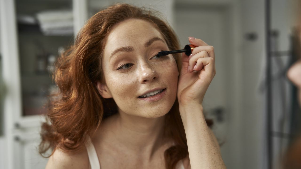 Best Lancome Mascaras - woman with red hair applying mascara