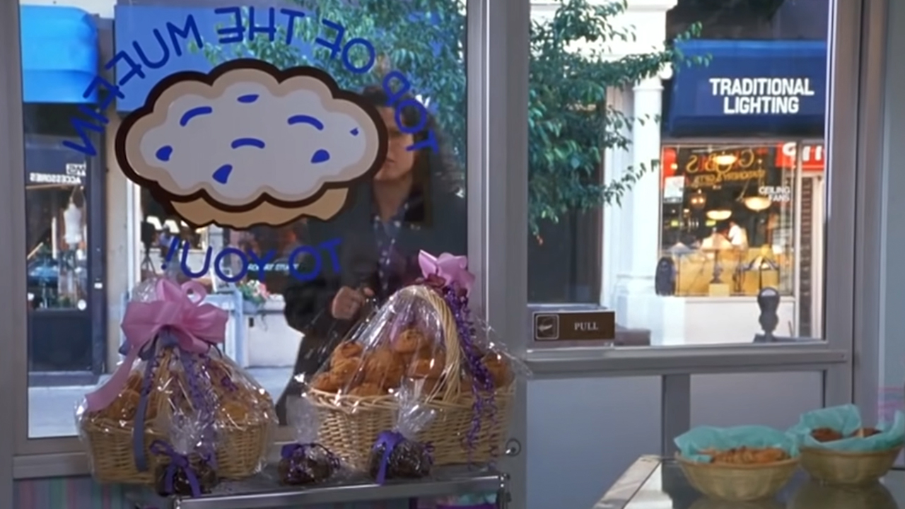 Elaine looking through the window of the store Top Of The Muffin To You on Seinfeld