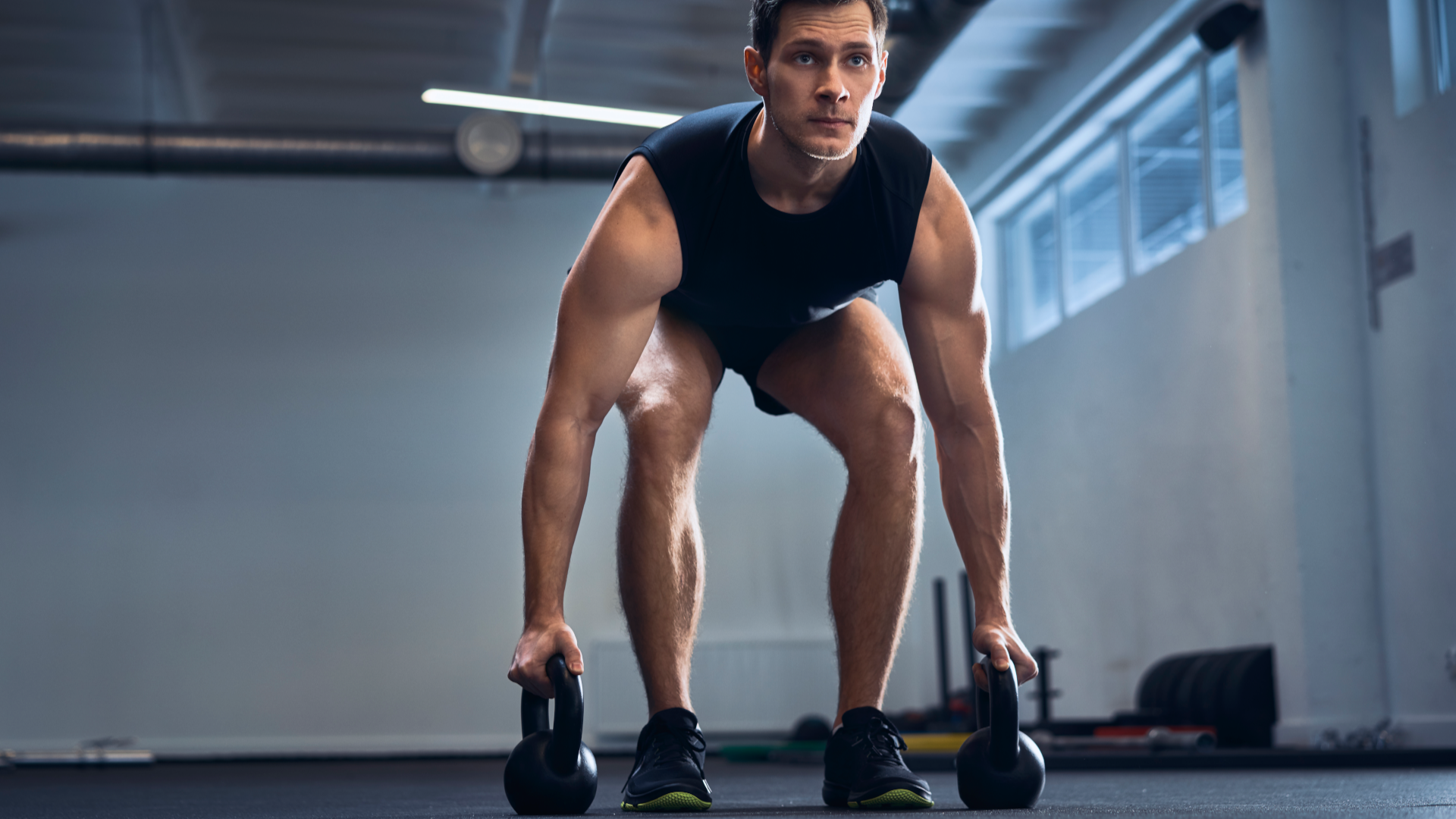 a man performing kettlebell gorilla rows