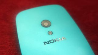 The Nokia 3210 on a red background.