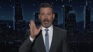 Jimmy Kimmel holding his hand up during monologue on Jimmy Kimmel Live!