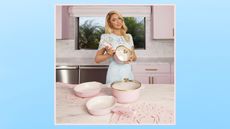 Paris Hilton kitchen set being held up by Paris in a blue dress in her pink kitchen