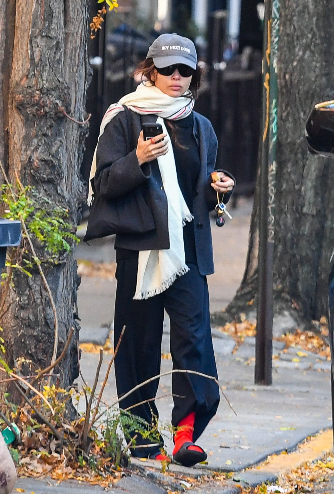 Zoë Kravitz wore the red socks trend with a neutral scarf, leaving her purple version at home