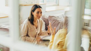 View through window of woman talking