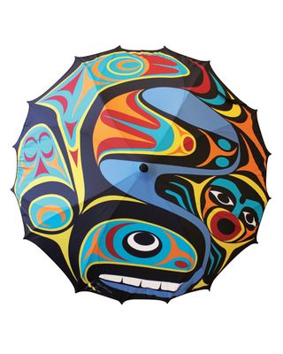 A colorful umbrella featuring whale artwork by artist Maynard Johnny Jr.