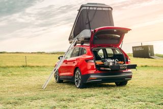 Škoda Enyaq iV 80 FestEVal with rooftop tent, ladder, and open boot with camping kit