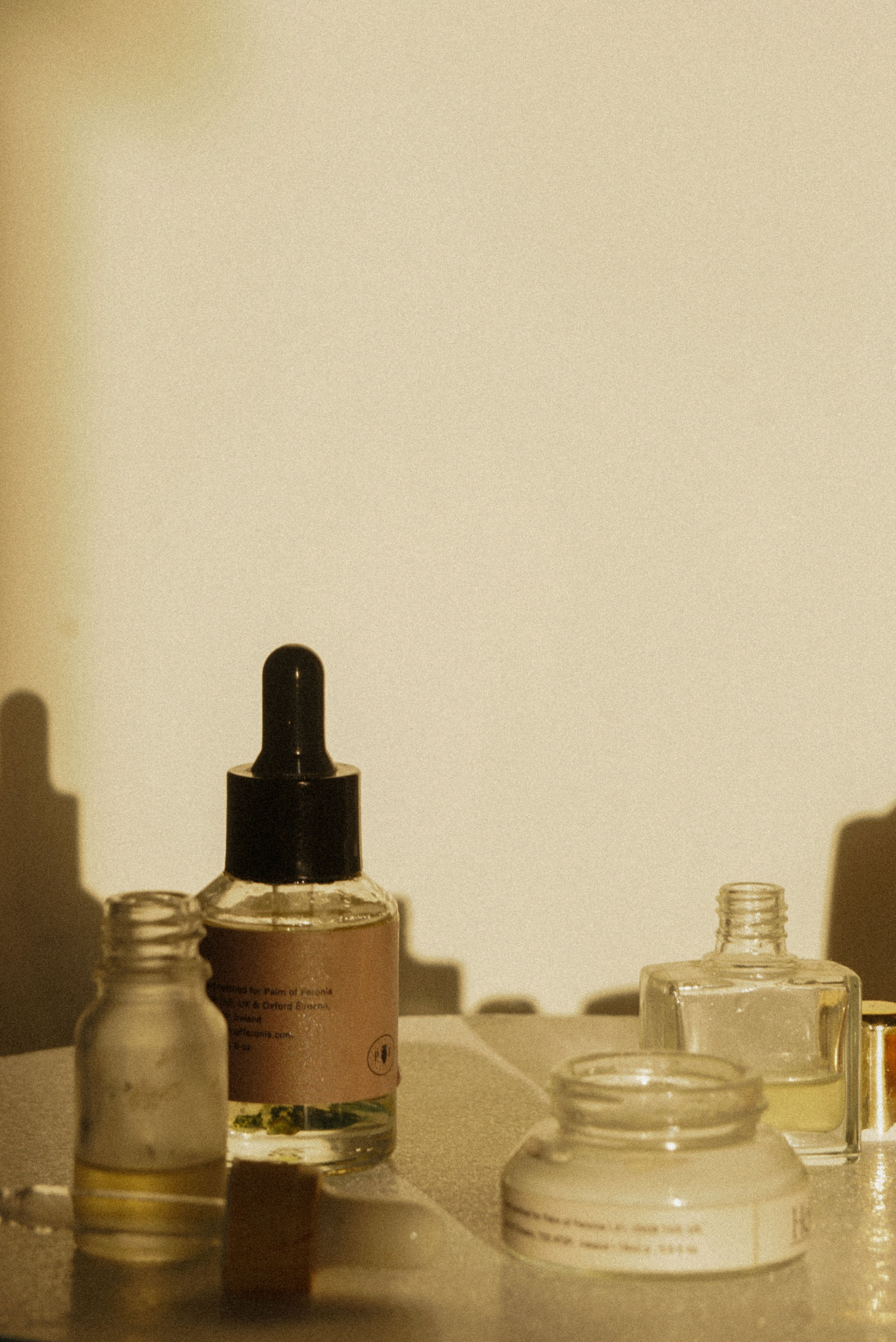 Glass bottles and jars of skincare products.