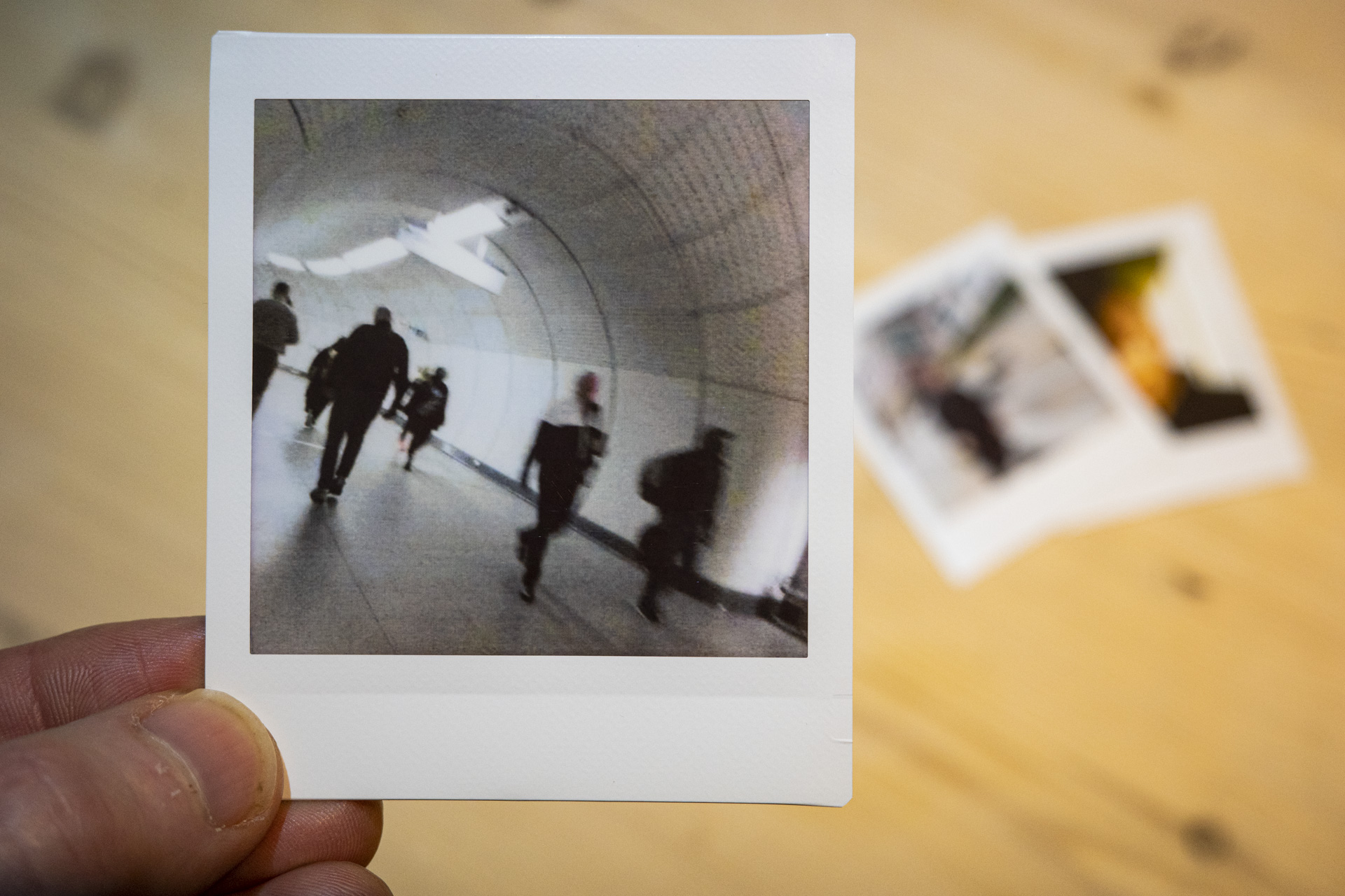 Fujifilm Instax Pal print of a street scene, on Link Square film,, in the hand