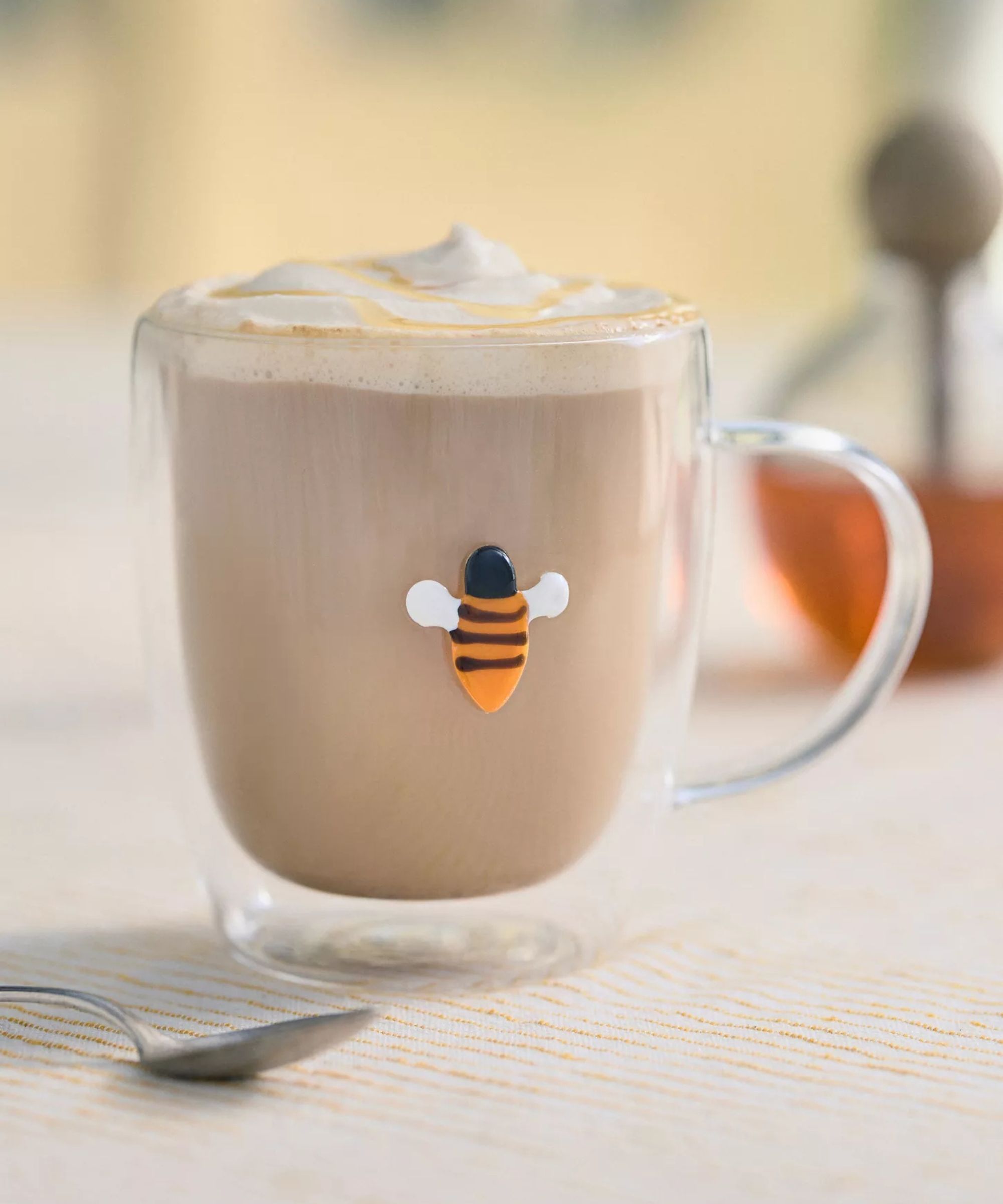 Glass hot chocolate mug with a small bumblebee design