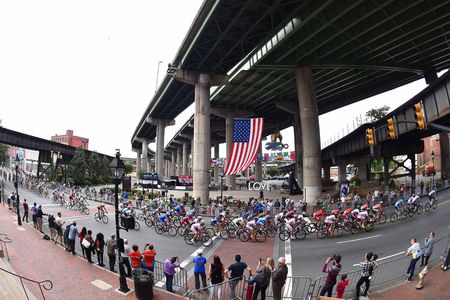 US flag waves over an elite men's road race