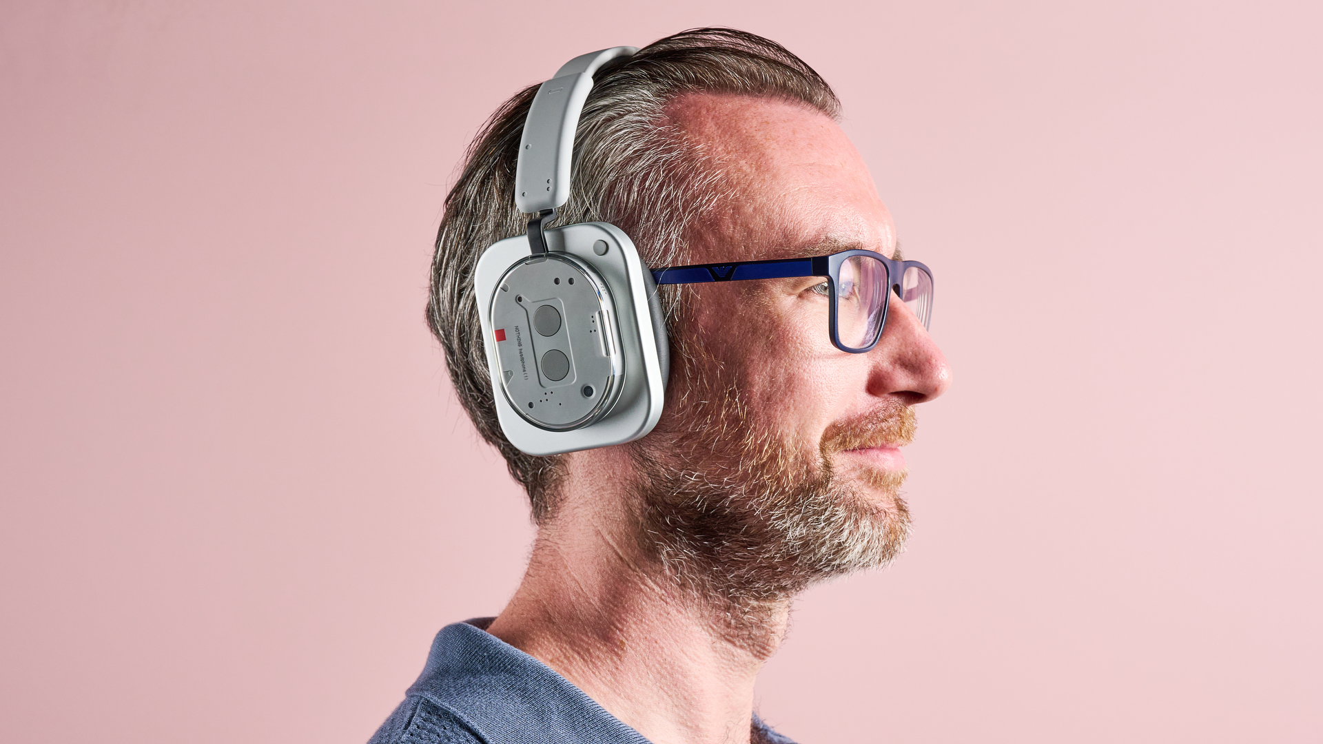The Nothing Headphone (1) on a man's head, shown from the side