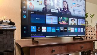 Samsung Q60D QLED TV on console in living room