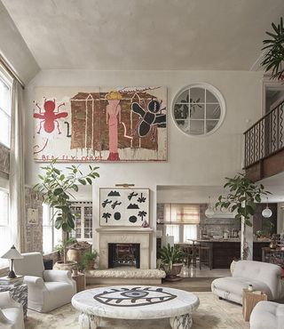 triple height living space interior with art and planting at Maison Colbert in London