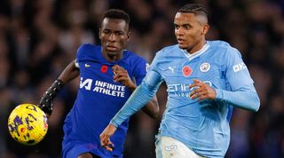 Chelsea's Nicolas Jackson and Manchester City's Manuel Akanji challenge for a ball in November 2023.