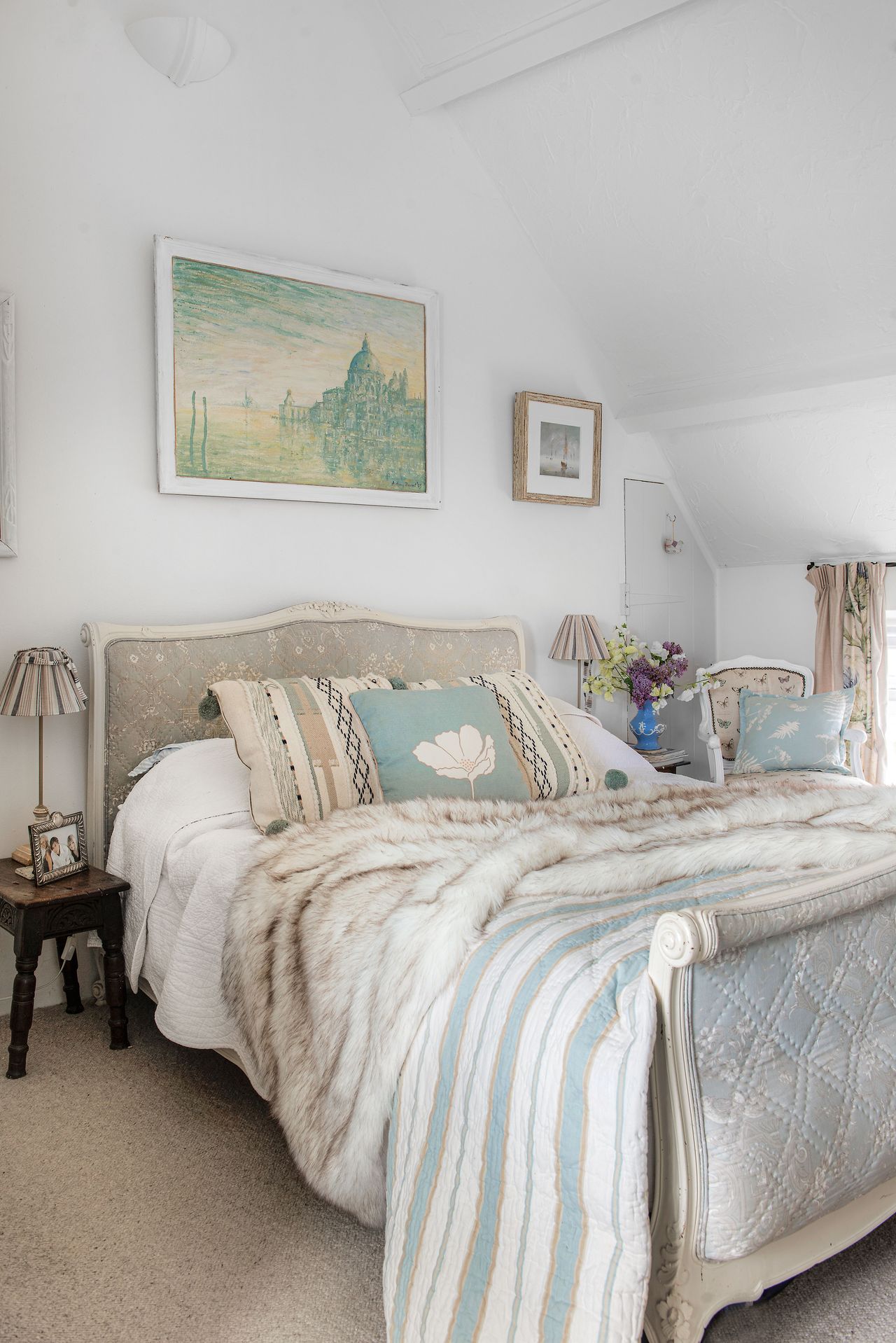 bedroom with French style double bed and striped bed cover
