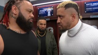 Tama Tonga looks on as Jacob Fatu and Solo Sikoa have a staredown.