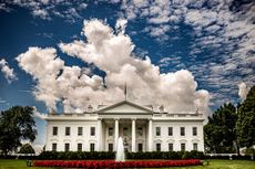 image of the White House with clouds above it