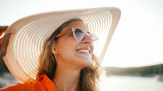 woman wearing hat and sunglasses on beach