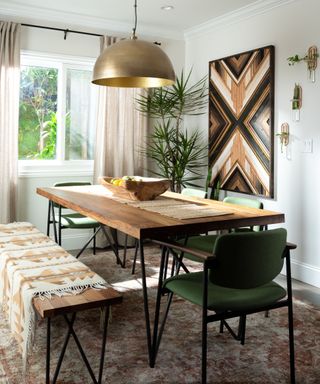 Green dining room designed by Hayley Orrantia, The Goldbergs actress, bohemian wall art