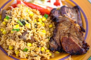 Cuban cuisine: deep pork fried and yellow rice - stock photo