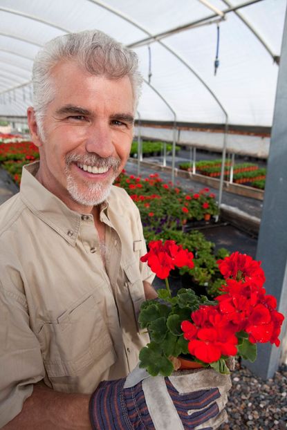 Gardener Holding Red Flowers