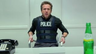 Ryan Reynolds sits stunned in front of a desk in R.I.P.D.