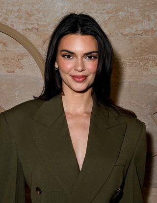 Kendall Jenner with dark subtly layered hair.