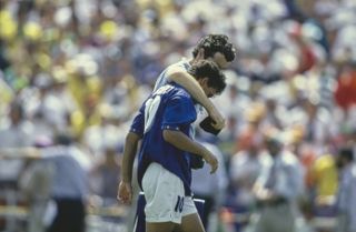 Italy's Roberto Baggio is consoled by a team official after missing a penalty in the shootout against Brazil in the 1994 World Cup final.