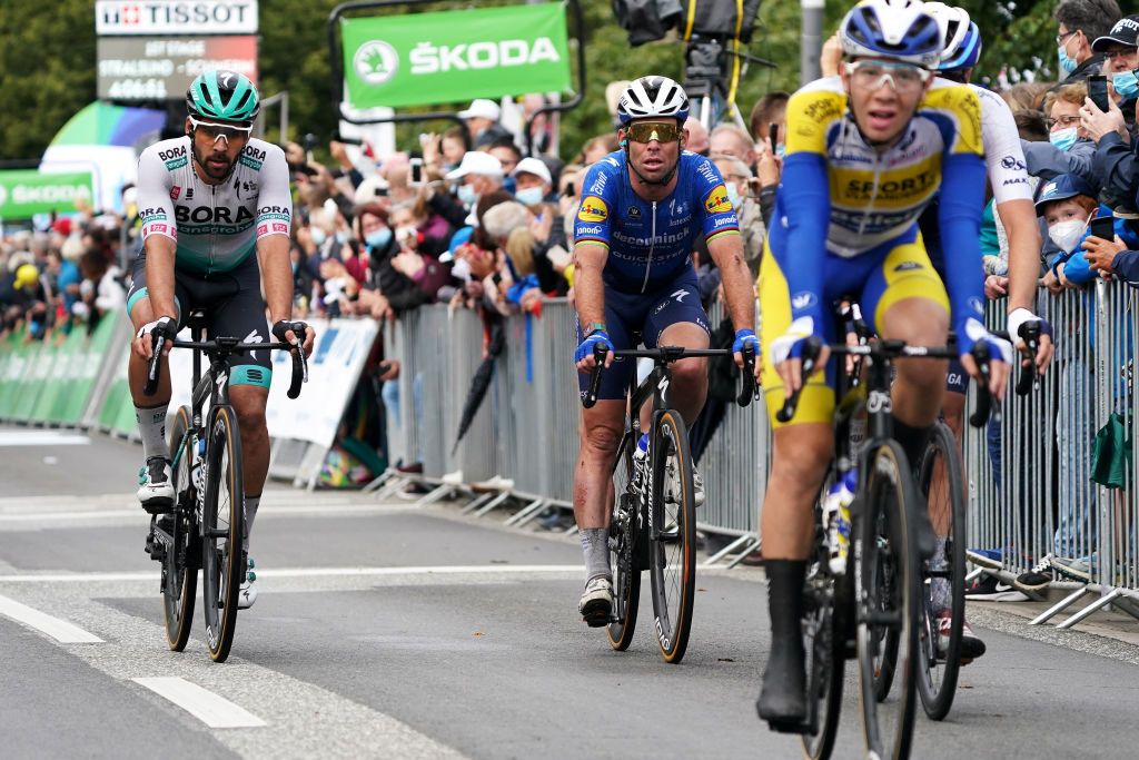 SCHWERIN GERMANY AUGUST 26 LR Michael Schwarzmann of Germany and Team Bora Hansgrohe and Mark Cavendish of United Kingdom and Team Deceuninck QuickStep crosse the finishing line during the 35th Deutschland Tour 2021 Stage 1 a 191km stage from Stralsund to Schwerin DeineTour on August 26 2021 in Schwerin Germany Photo by Christian KasparBartkeGetty Images