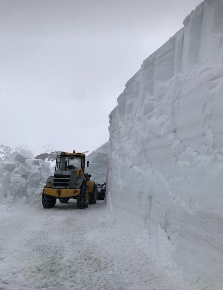 The diggers work to clear the Passo Gavia