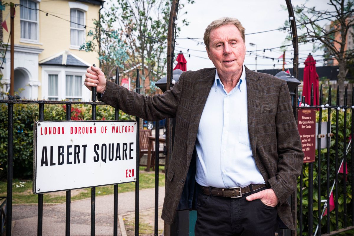 Football legend Harry Redknapp standing by the Albert Square sign in EastEnders 