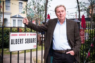 EastEnders: Football legend Harry Redknapp standing by the Albert Square sign 