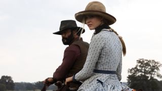 Isabel May on a horse with Tim McGraw on a horse behind her.