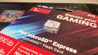 Photo of the 1TB PNY Switch 2 microSD Express card sitting on top of the handheld.