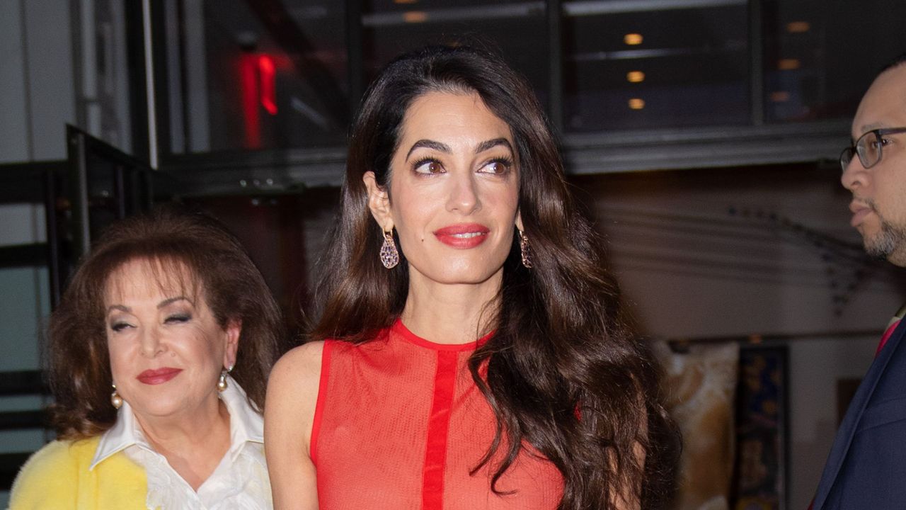 Amal Clooney wearing a sheer red dress