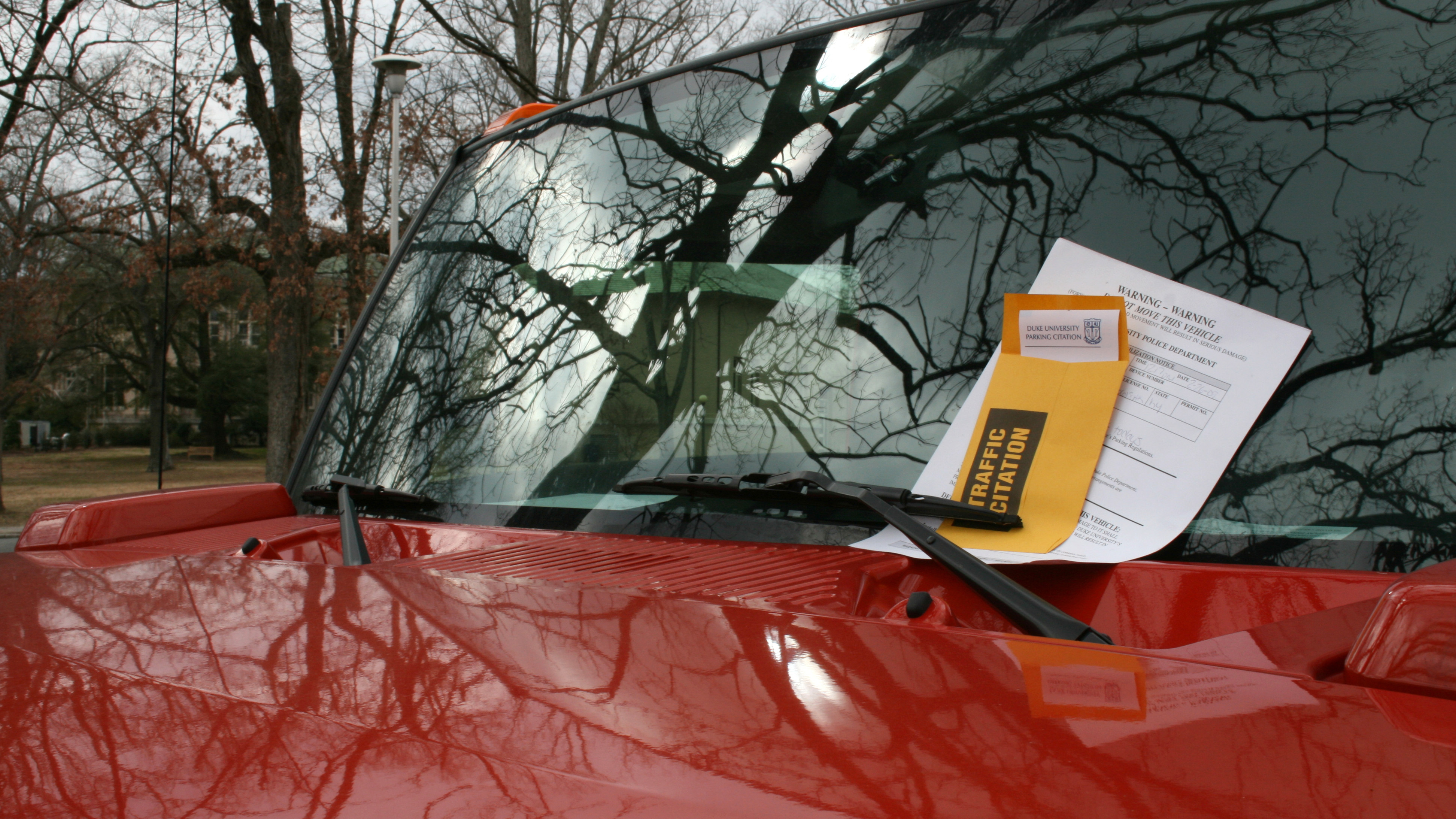 A parking ticket left on a car windscreen