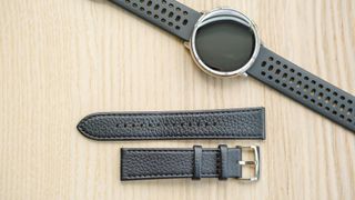 Close up of the premium black leather strap next to the Amazfit Active 2 on the standard black silicone strap