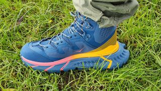 Man wearing Hoka OneOne TenNine Hike GTX boots on the grass