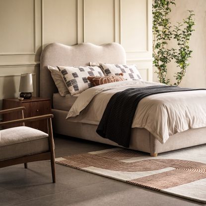 Bedroom with a bed with a curved headboard